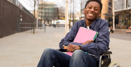 black person in wheel chair smiling